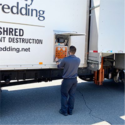 Security Shredding employee loading a shred truck