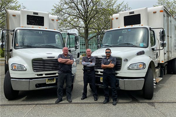 Security Shredding truck drivers posing in front of shred trucks