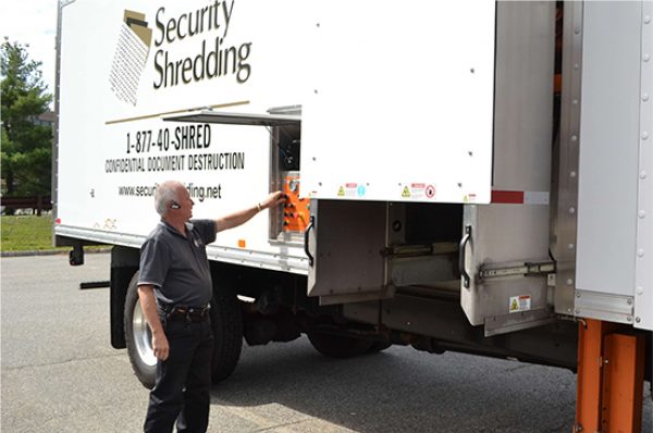 Security Shredding truck driver picking up shredding documents