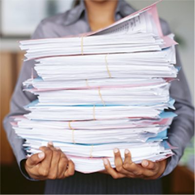 Person carrying a pile of shredding documents