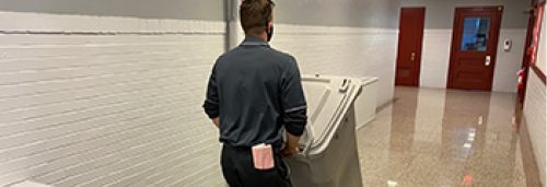 Security Shredding employee picking up a residential shred bin
