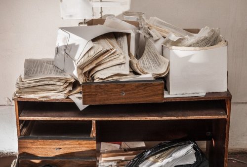 Cluttered pile of documents on a desk